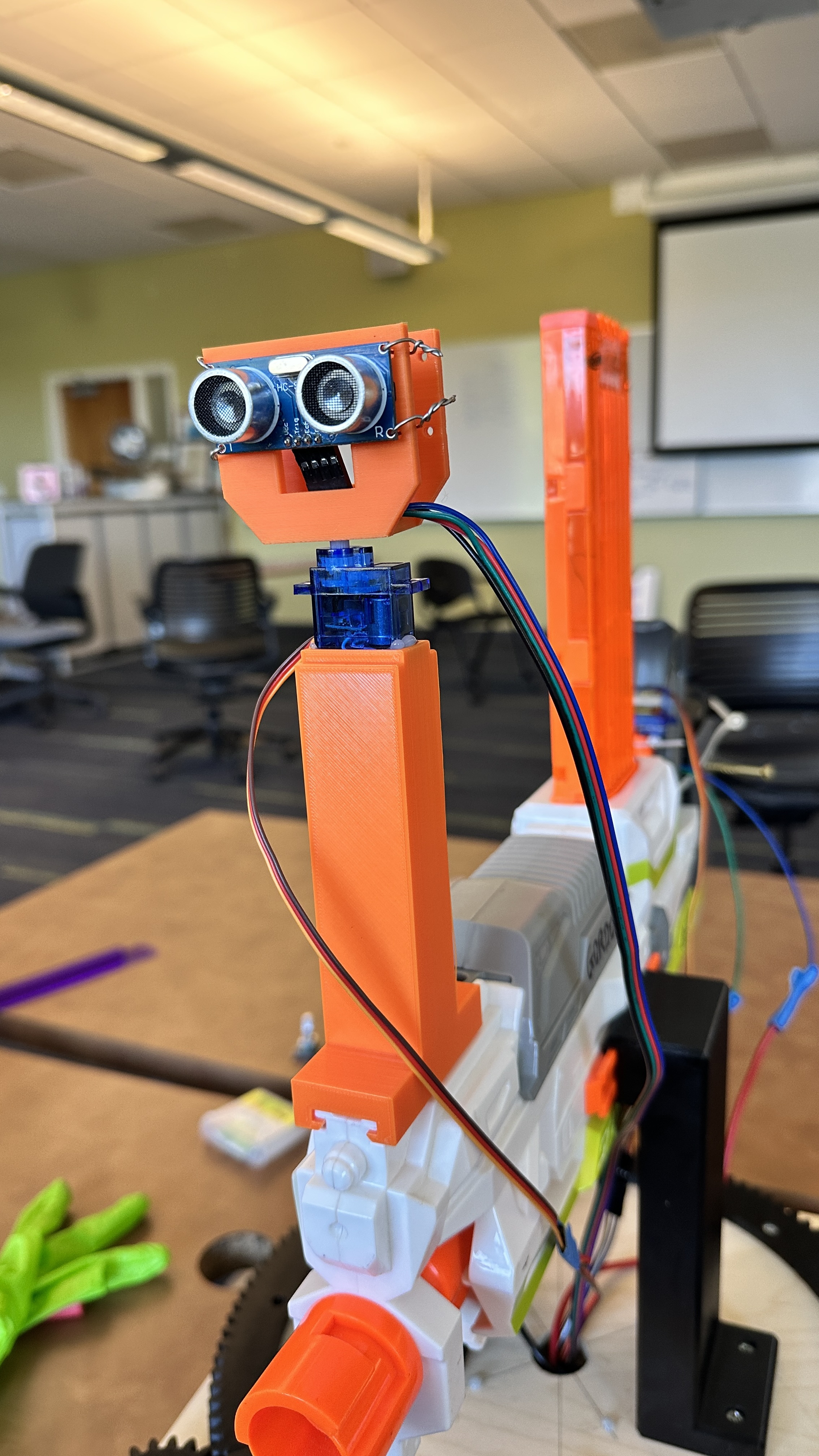 HC-SR04 ultrasonic sensor mounted on an SG90 servo and orange 3D-printed mast